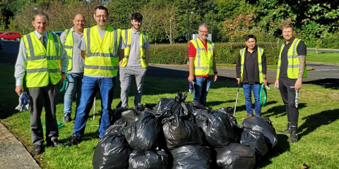 group of employees picking up trash