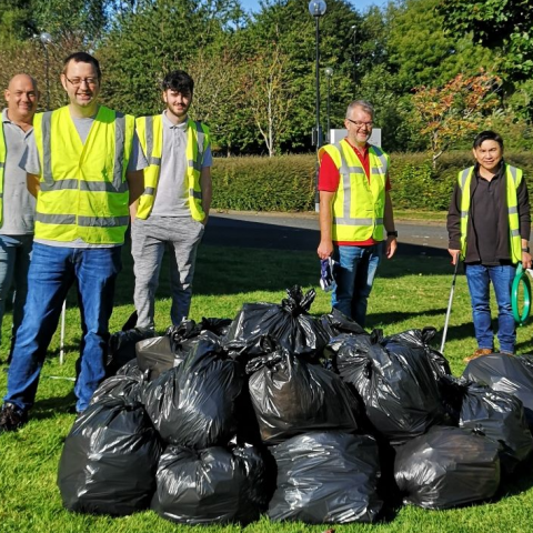 group of employees picking up trash