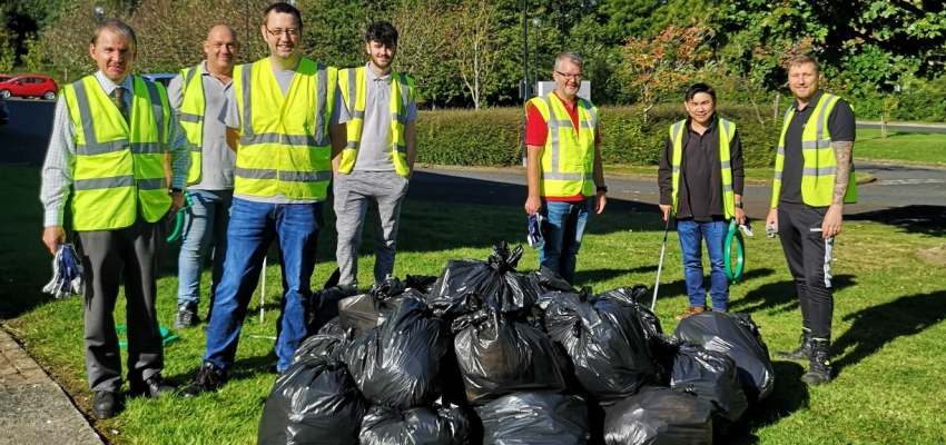 group of employees picking up trash