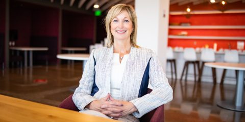 A photo of Lynnette Heath sitting at the nVent office and smiling at the camera
