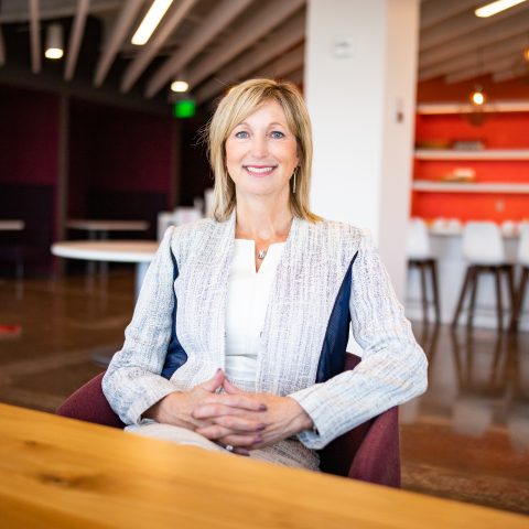 A photo of Lynnette Heath sitting at the nVent office and smiling at the camera